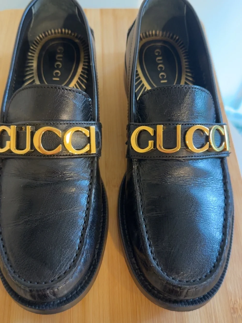 Gucci Black Leather Men’s Slip-On Loafers with Gold Logo Band